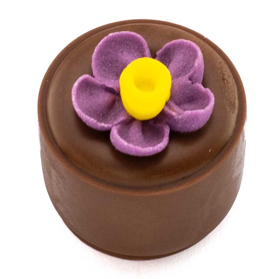 Smooth hazelnut Praline in pure couverture milk chocolate shell topped with an orange/yellow sugar flower