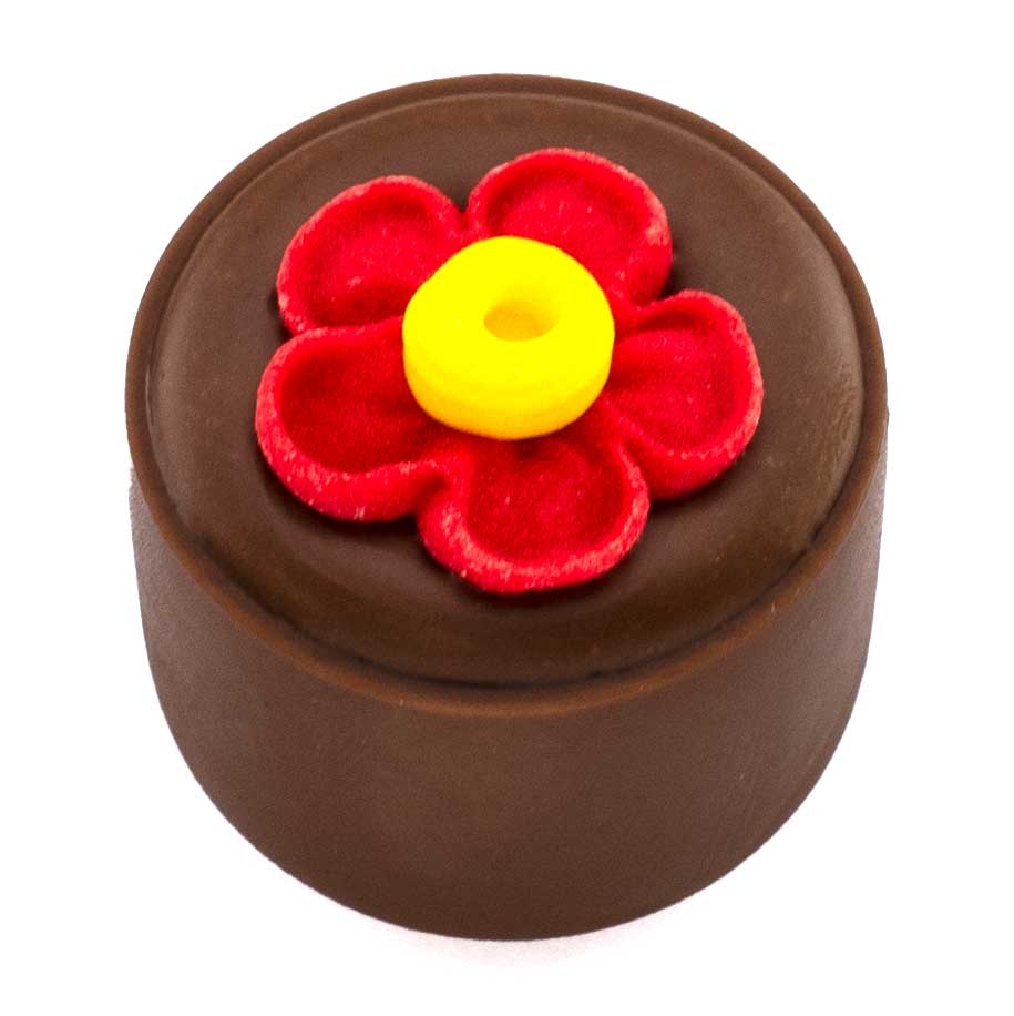 Smooth hazelnut praling in pure couverture milk chocolate shell topped with a red/yellow sugar flower